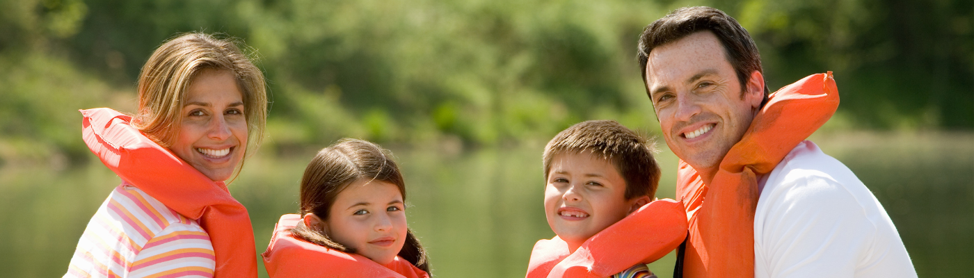 Family In A Little Boat With Life Jackets on